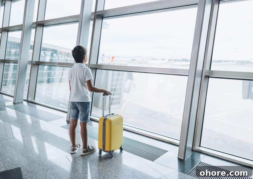 Top Carry-On Luggage Picks for Every Type of Trip 3 Boy standing with yellow carry-on luggage at airport.