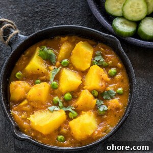 Instant Pot Aloo Matar (Potatoes and Peas Curry) 8 instant pot aloo matar served in a small black skillet