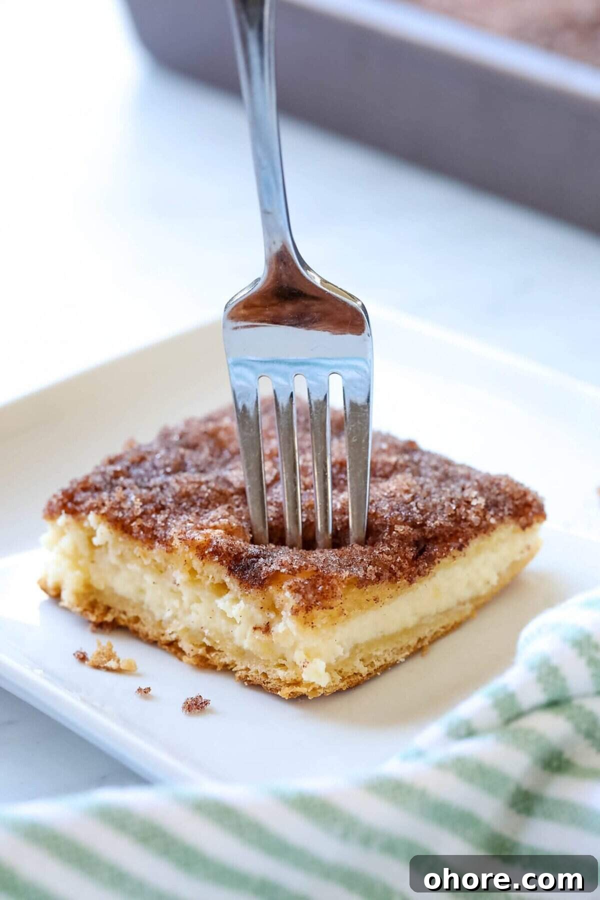 easy creamy cheesecake recipe sopapilla cheesecake bars with a fork sticking out