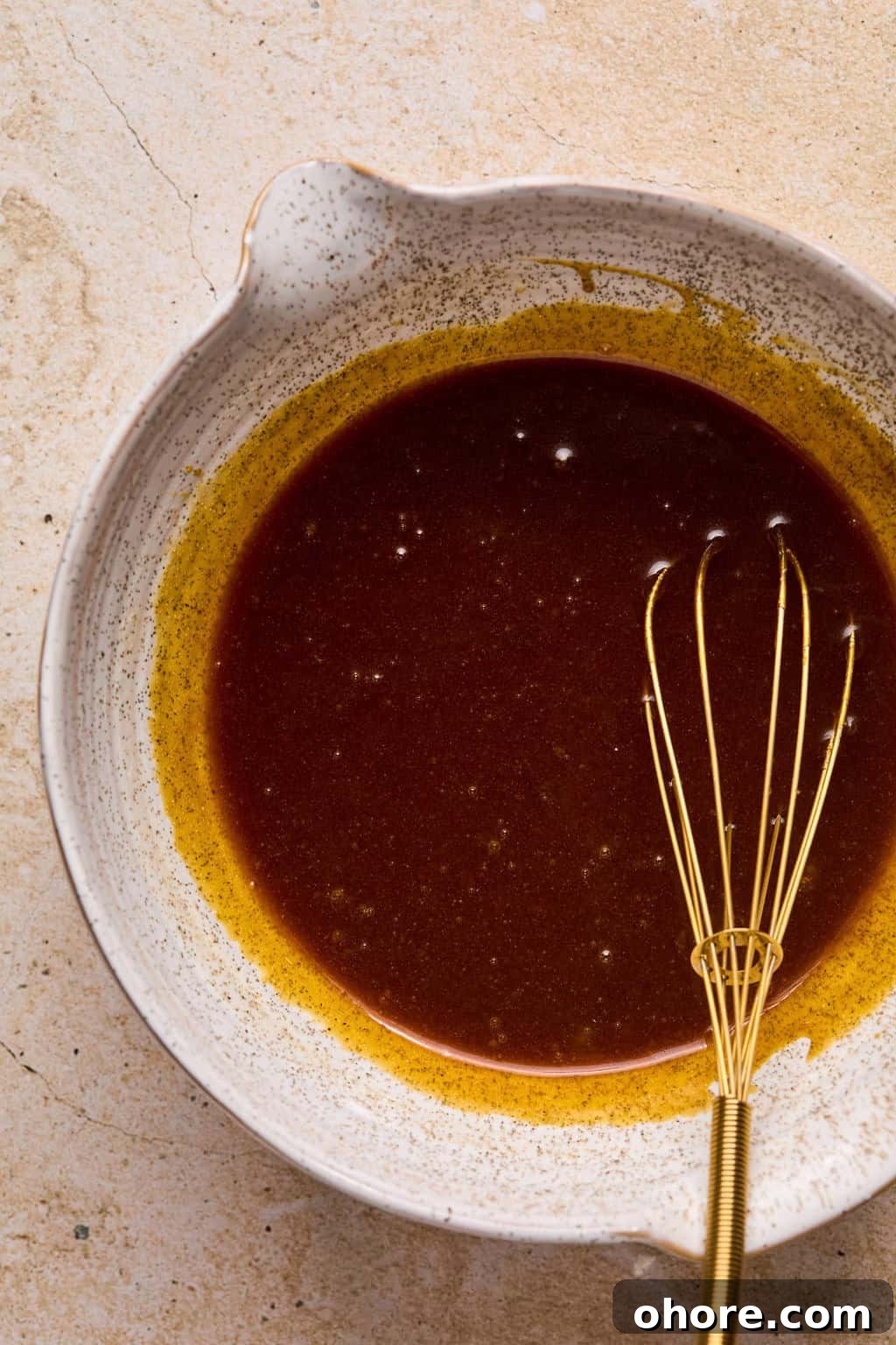 Pumpkin Spice Molasses Cookies Recipe for Cozy Fall Baking 5 Whisked molasses cookie wet ingredients with whisk propped in it.