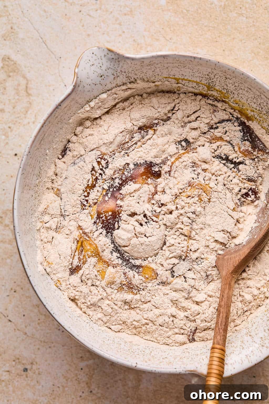 Pumpkin Spice Molasses Cookies Recipe for Cozy Fall Baking 7 Dry and wet ingredients for pumpkin molasses cookies being combined in bowl.