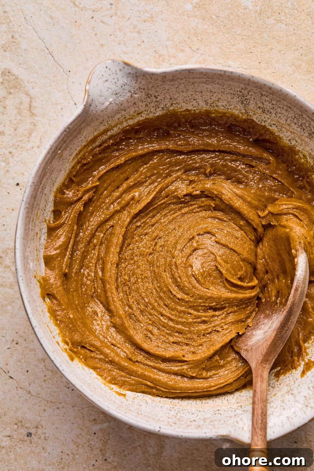 Pumpkin Spice Molasses Cookies Recipe for Cozy Fall Baking 8 Molasses cookie dough mixed in bowl with wooden spoon.