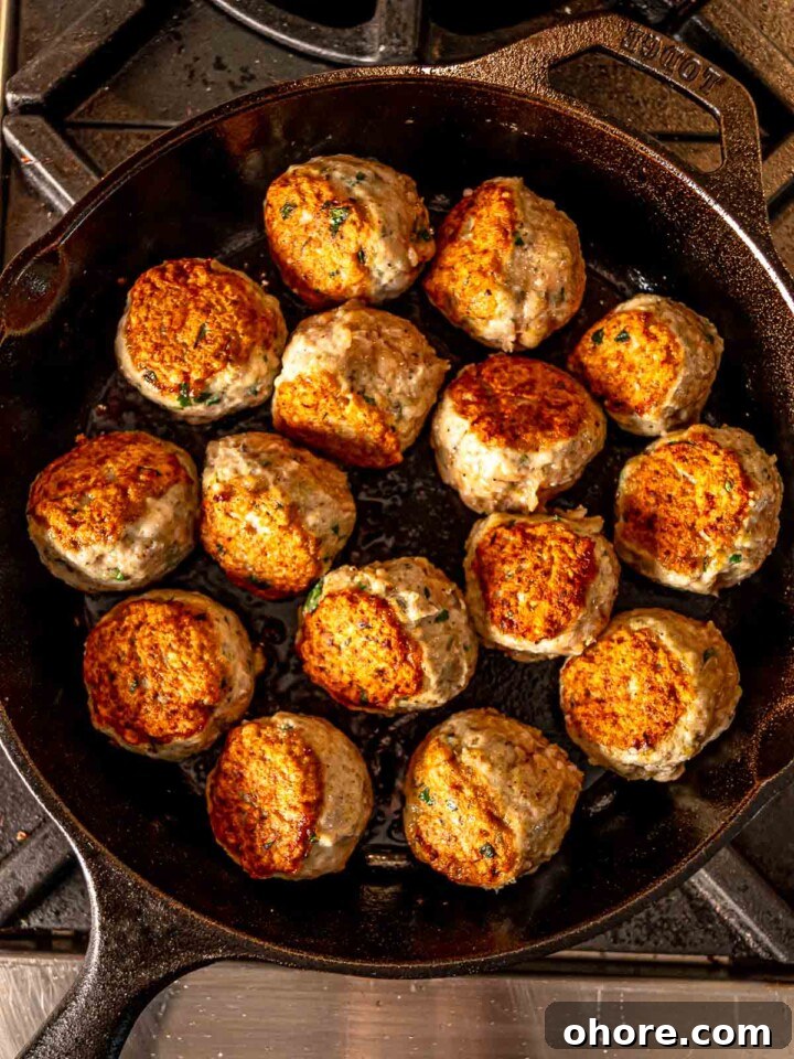 Baked Chicken Parmesan Meatballs Recipe That Melts in Your Mouth 5 Seared meatballs in a skillet
