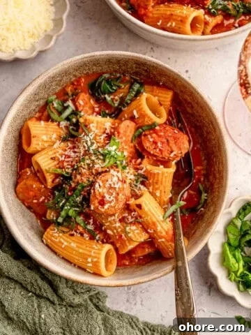 A bowl of rigatoni with sausage.