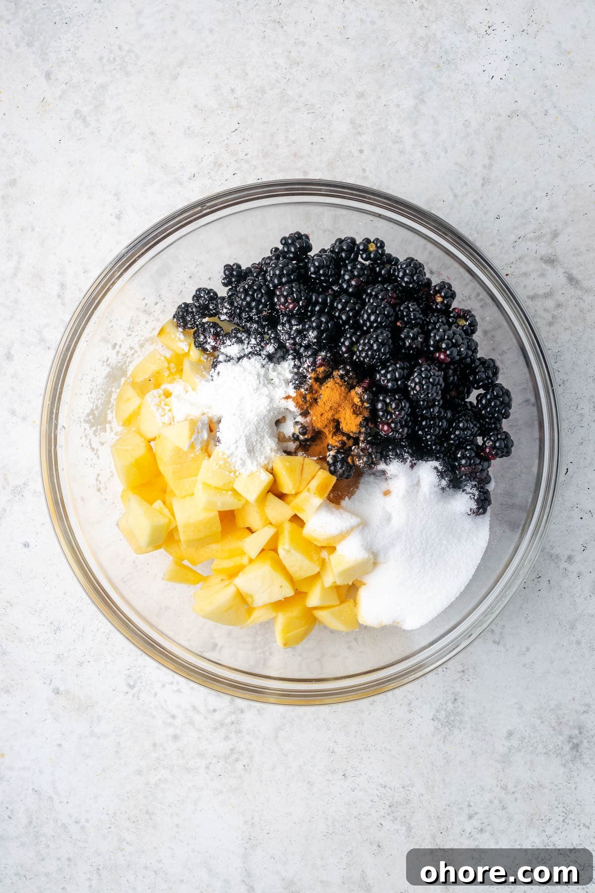 Apple & Blackberry Crumble Recipe: Rustic Autumn Dessert 5 Blackberries, apples, sugar, cornstarch, lemon juice, vanilla extract, cinnamon and salt combined in a large mixing bowl.