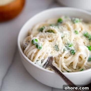 Cottage cheese pasta swirled into a bowl with a fork.