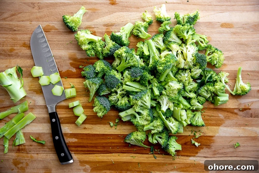 Broccoli Pasta Kids Will Actually Love: Creamy Weeknight Recipe 5 Chopped broccoli on cutting board with knife for the broccoli pasta