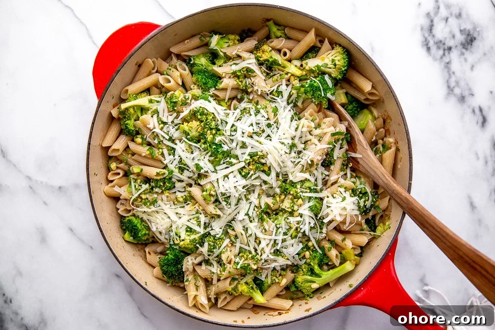 Broccoli Pasta Kids Will Actually Love: Creamy Weeknight Recipe 8 Broccoli pasta in a large skillet with a wooden spoon.