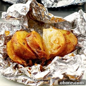 Crispy Baked Potatoes with Onion Soup Mix Seasoning 14 cooked, sliced, onion baked potato on foil