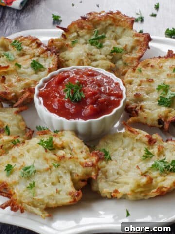 shredded air fryer potato pancakes on a white plate with a white bowl of salsa in the middle