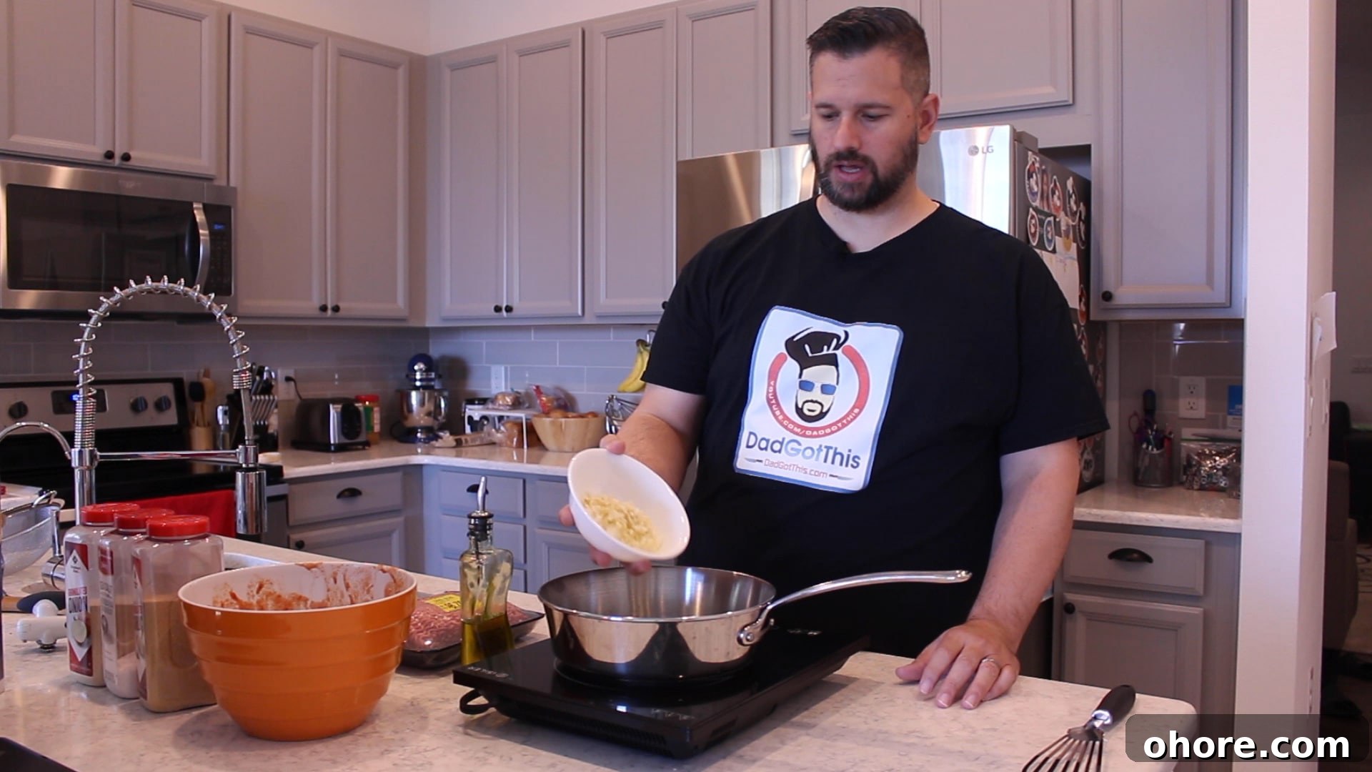 Quick Homemade Meat Sauce Recipe for Pasta and Lasagna 6 Dad putting onions and garlic in pan