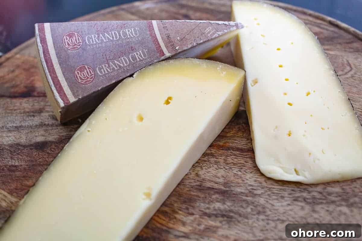Three triangles of cheese on wooden board.