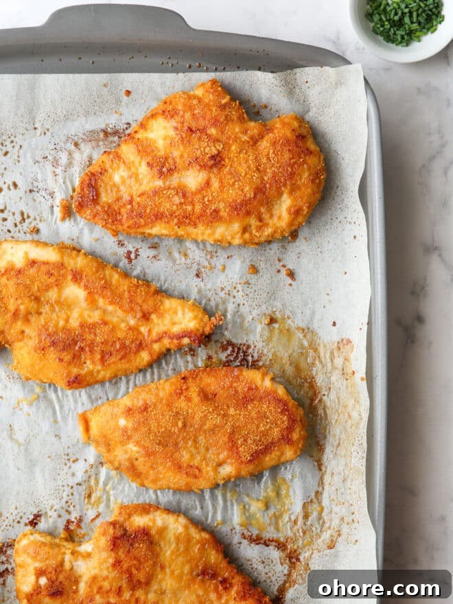Crispy Oven-Fried Chicken Recipe: Juicy, Golden, and Tender 9 baked oven fried chicken on a sheet pan