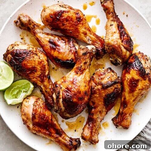 Baked hot honey chicken drumsticks on a plate.