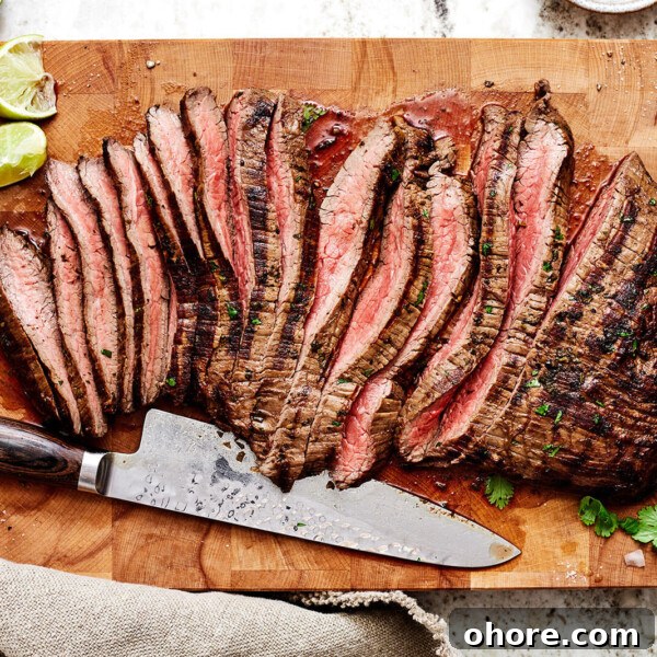Sliced carne asada on a wooden board
