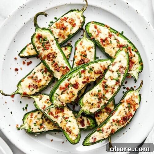 A white plate of jalapeño poppers.