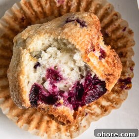 Cherry Almond Muffins: Homemade Cherry Muffin Recipe with Almond Extract 8 cherry muffin with a bite on open paper liner