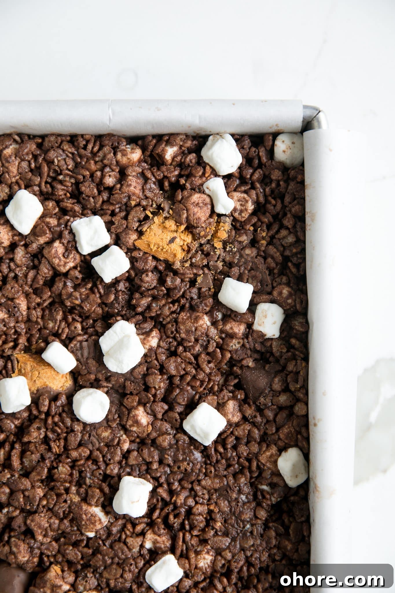 Chocolate Peanut Butter Rice Krispie Treats Recipe for Crispy Bars 3 Prepared Rice Krispie Treats in a baking pan with Butterfinger bars