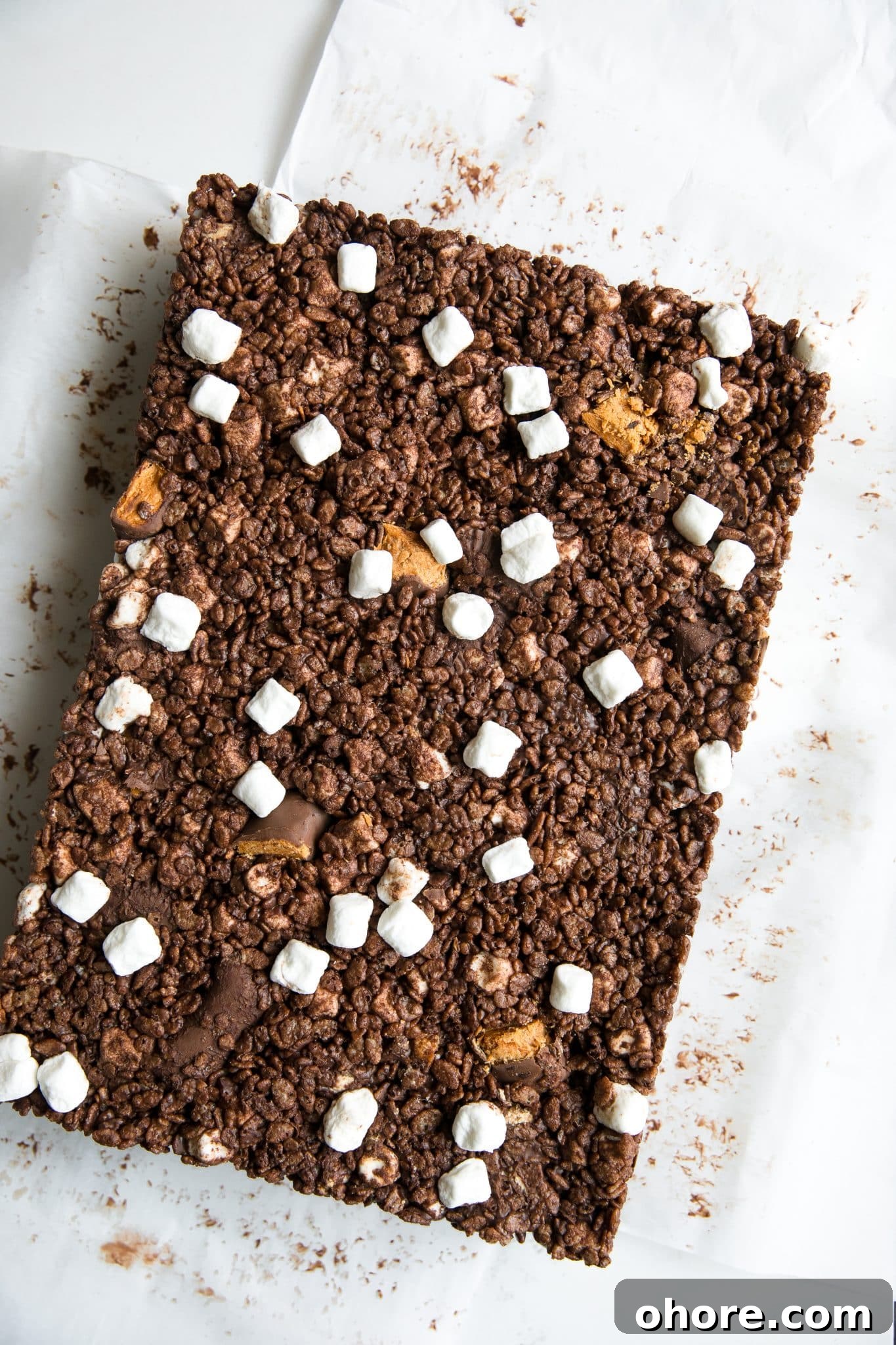 Chocolate Peanut Butter Rice Krispie Treats Recipe for Crispy Bars 5 Chocolate Rice Krispie Treats with mini Butterfinger bars, dark chocolate, and peanut butter.