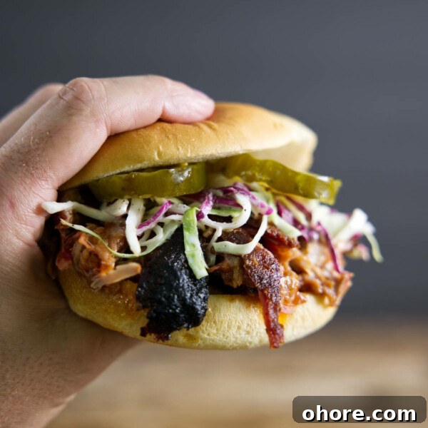 Juicy Smoked Pork Loin Recipe for Tender, Flavorful Results 16 Pulled pork sandwich made from smoked pork butt (smoked pork shoulder). With pickles, slaw, and BBQ sauce.