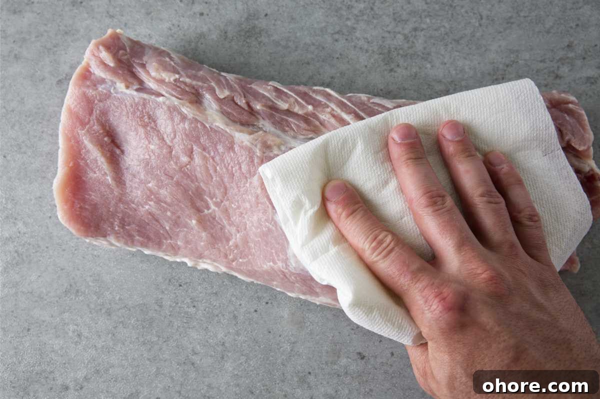 Juicy Smoked Pork Loin Recipe for Tender, Flavorful Results 7 patting dry a pork loin