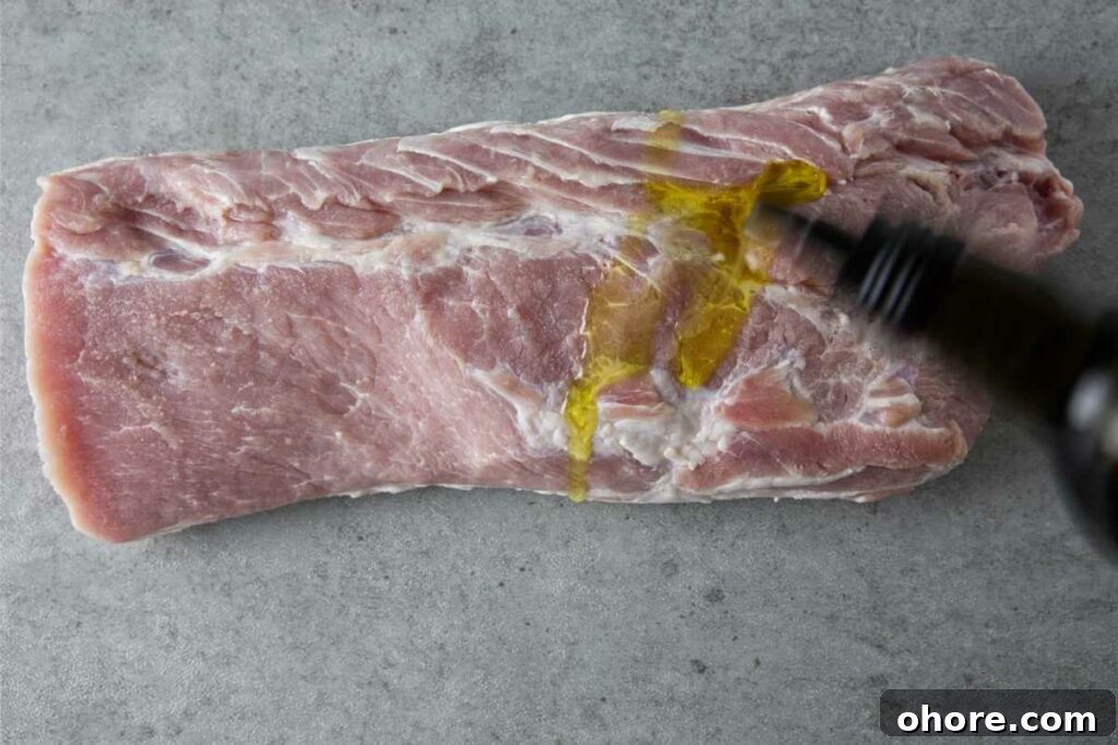 Juicy Smoked Pork Loin Recipe for Tender, Flavorful Results 8 adding oil to the pork loin