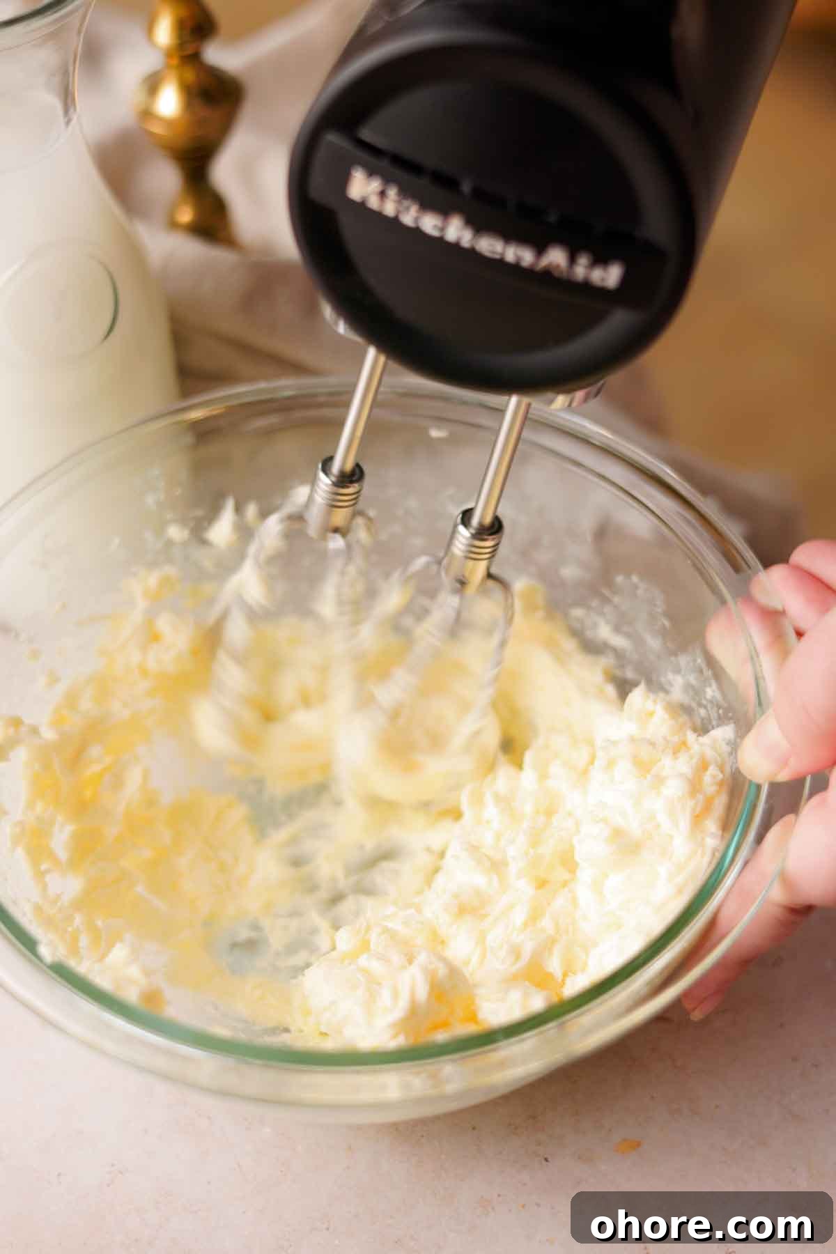 Ferrero Rocher Cupcakes Recipe: Decadent Hazelnut Chocolate Cupcakes 13 beating butter with a black electric handheld mixer in a glass bowl