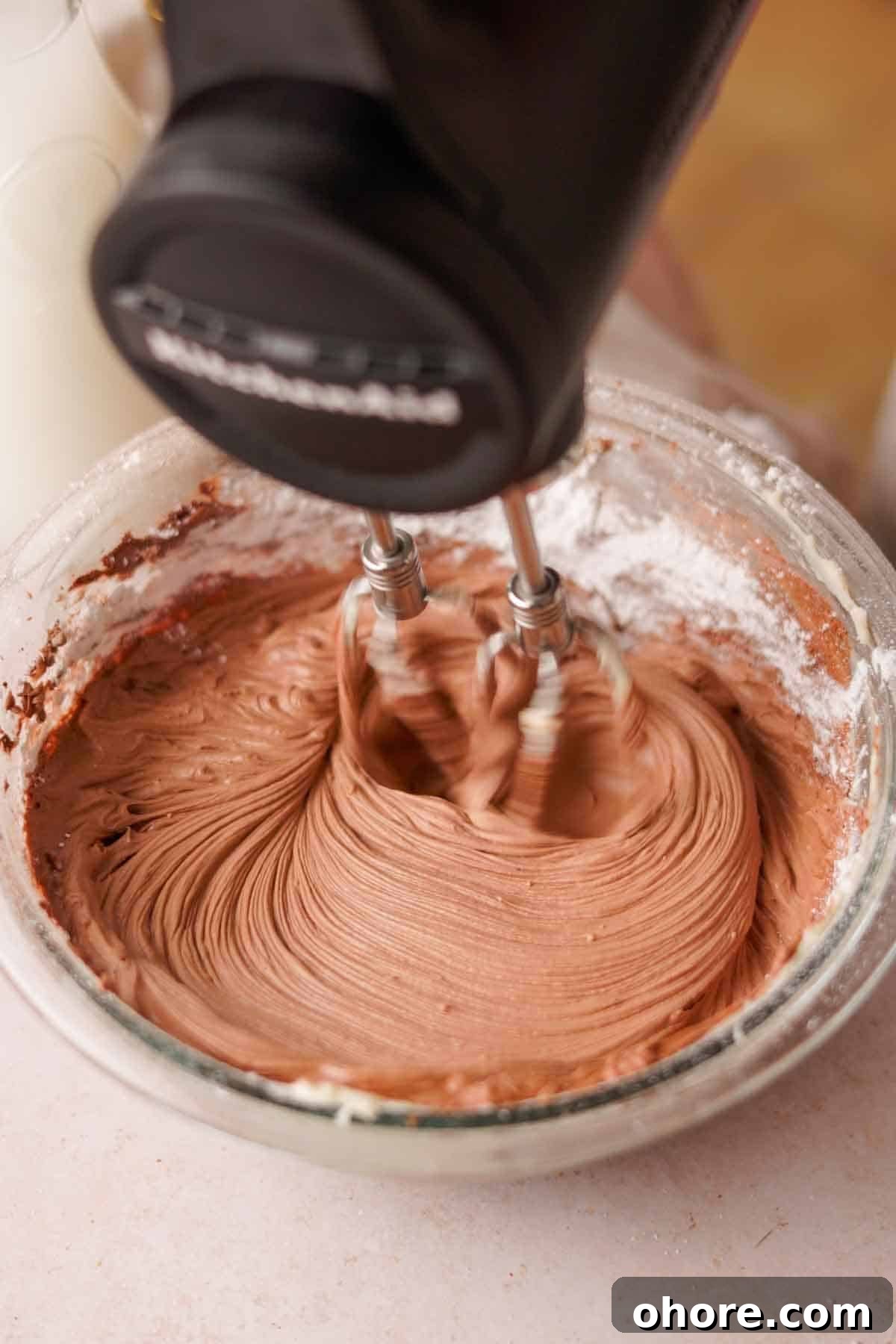 Ferrero Rocher Cupcakes Recipe: Decadent Hazelnut Chocolate Cupcakes 16 using an electric mixer to mix cocoa powder into nutella frosting