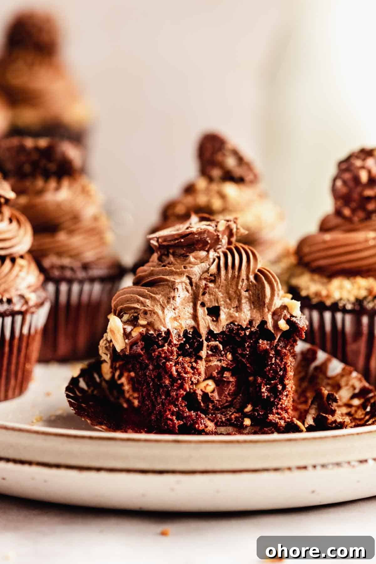 Ferrero Rocher Cupcakes Recipe: Decadent Hazelnut Chocolate Cupcakes 19 bitten chocolate cupcake stuffed with ferrero rocher and topped with creamy nutella buttercream