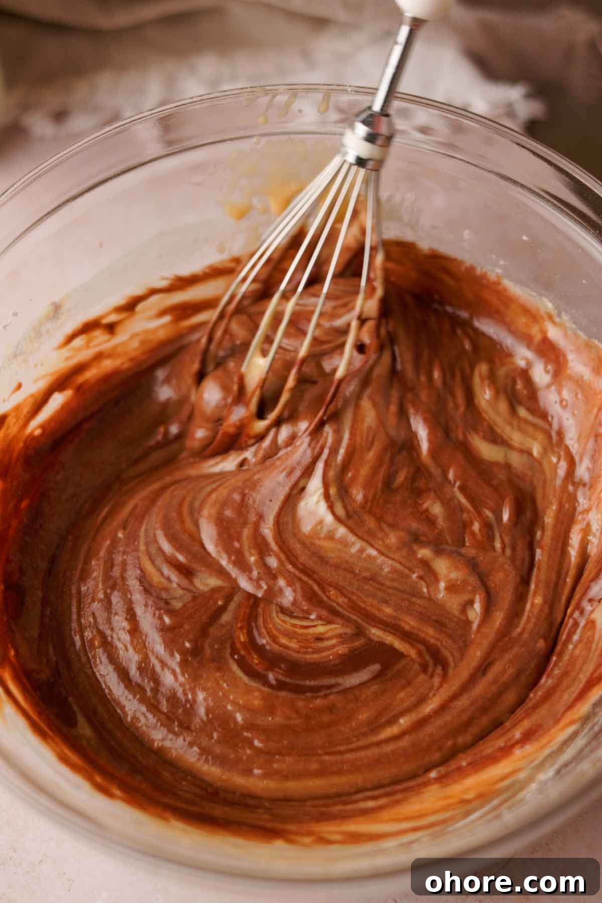 Ferrero Rocher Cupcakes Recipe: Decadent Hazelnut Chocolate Cupcakes 10 whisking chocolate cupcake batter with a whisk