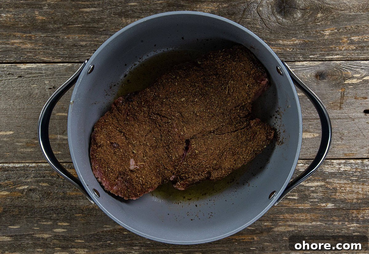 Keto Dutch Oven Pot Roast Recipe — Tender Low-Carb Roast 5 Seasoned roast in a Dutch oven.