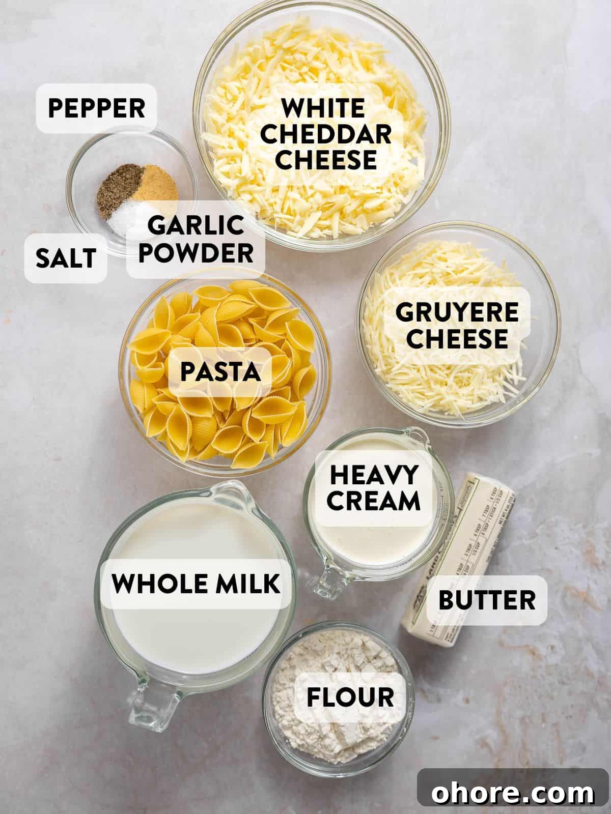 Creamy White Cheddar Macaroni and Cheese Recipe 4 ingredients for white cheddar mac and cheese on a counter.