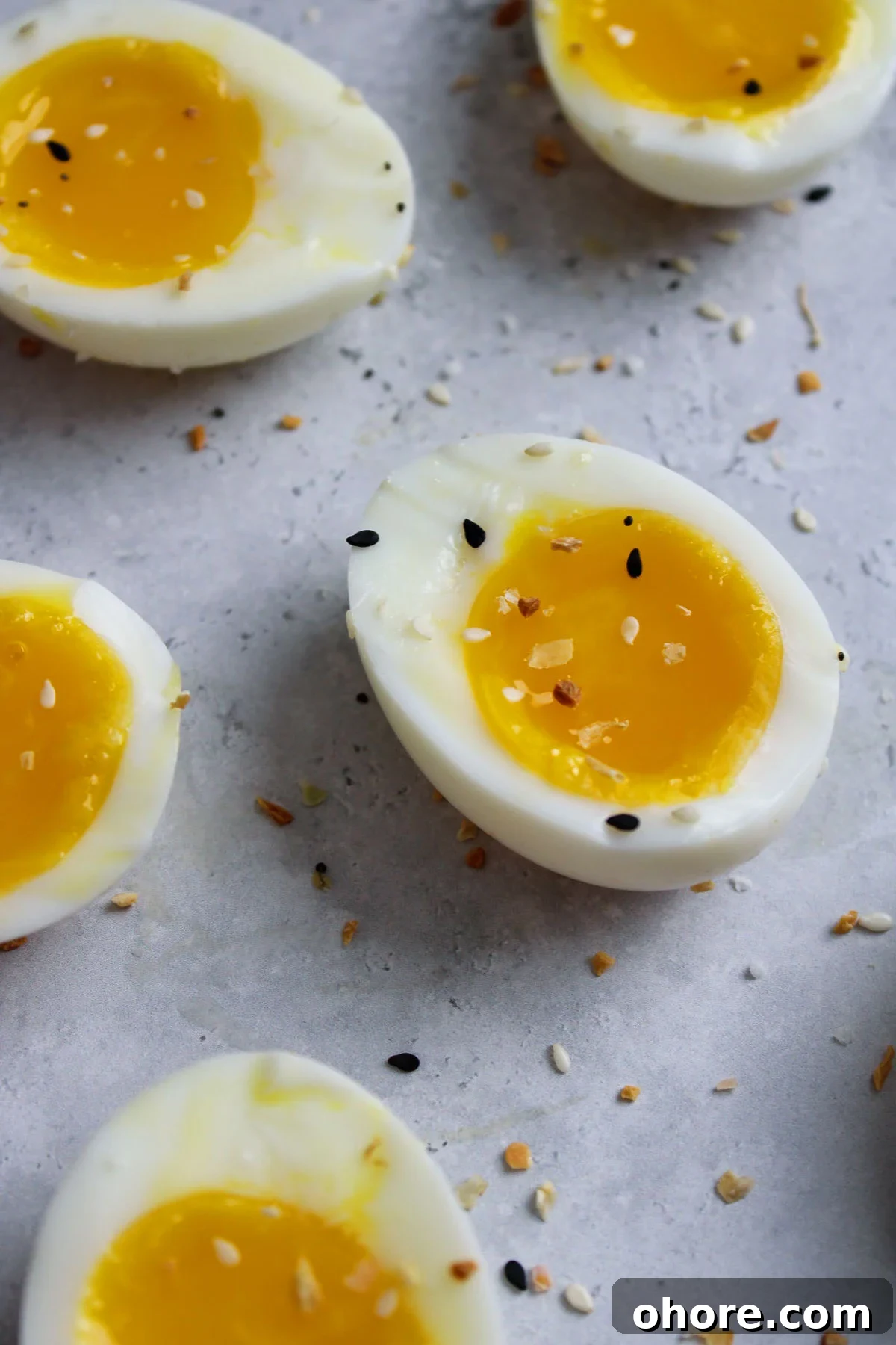 Perfect Jammy Eggs Recipe: Soft-Boiled Egg Guide 2 Jammy eggs cut in half on the counter.