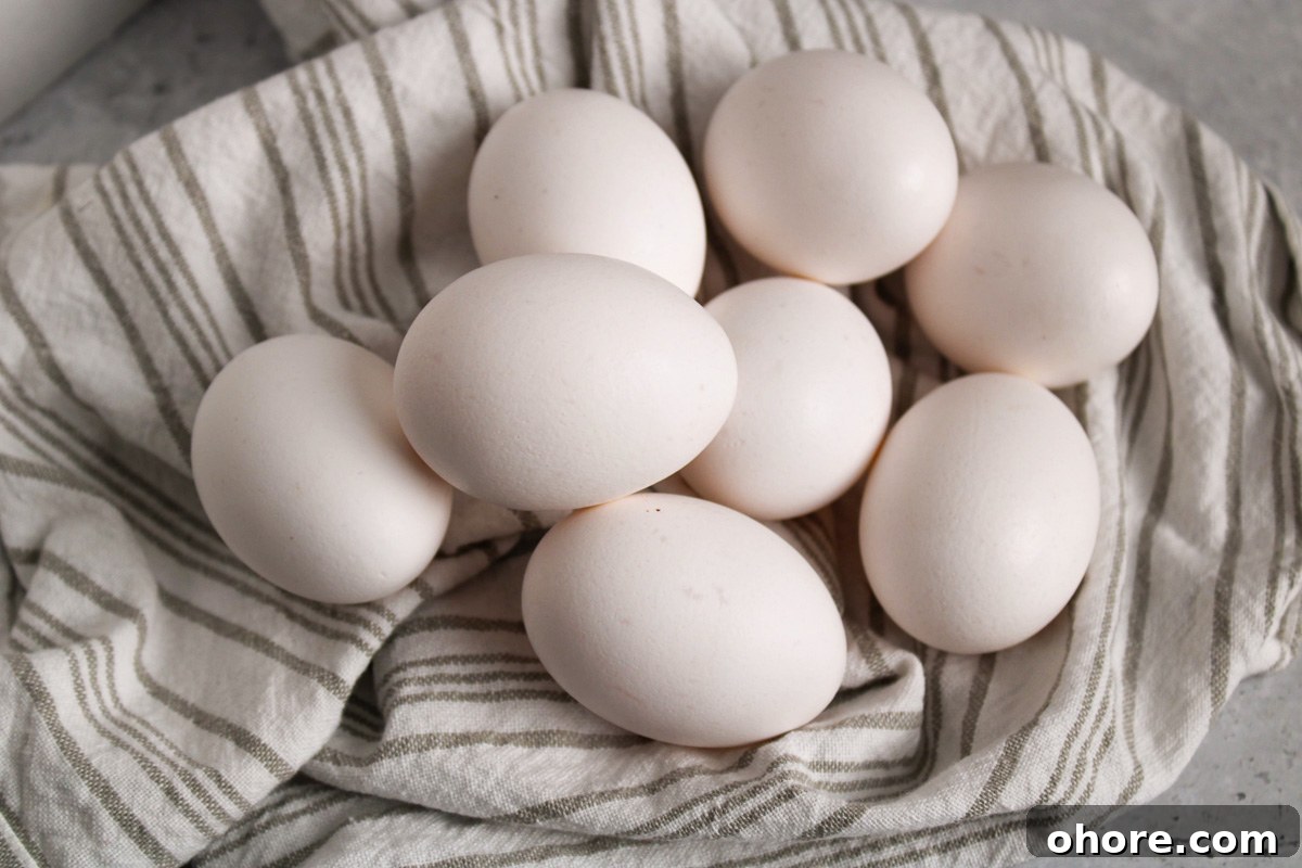 Perfect Jammy Eggs Recipe: Soft-Boiled Egg Guide 3 Pile of raw eggs on a towel.