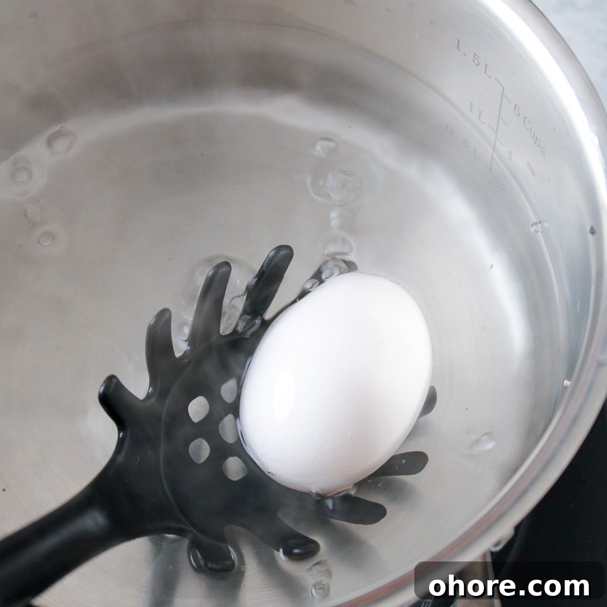 Perfect Jammy Eggs Recipe: Soft-Boiled Egg Guide 4 Carefully dropping an egg into the boiling water.