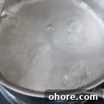 Perfect Jammy Eggs Recipe: Soft-Boiled Egg Guide 9 Boiling pot of water.