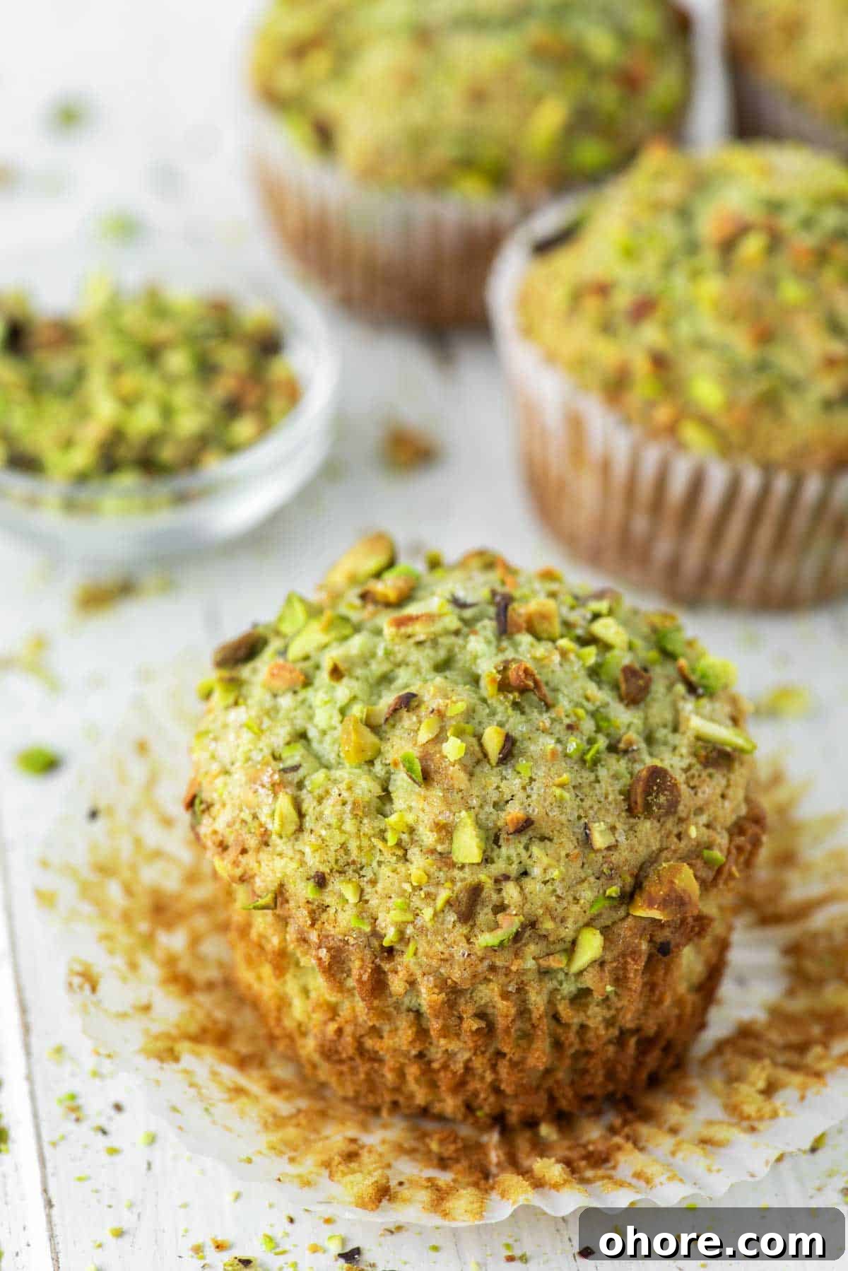 close-up pistachio muffin with more in the background