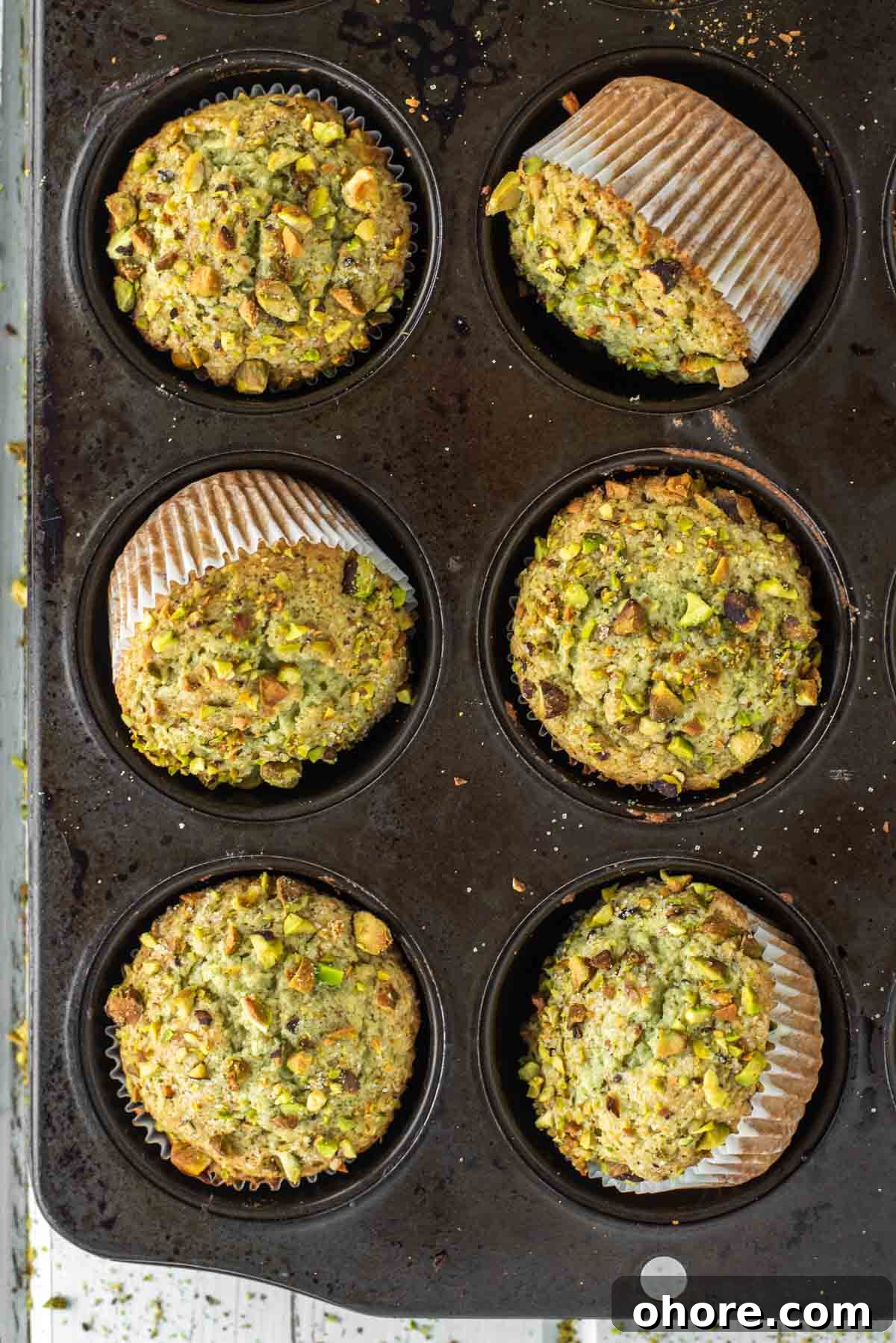 overhead shot of pistachio muffins in muffin tin