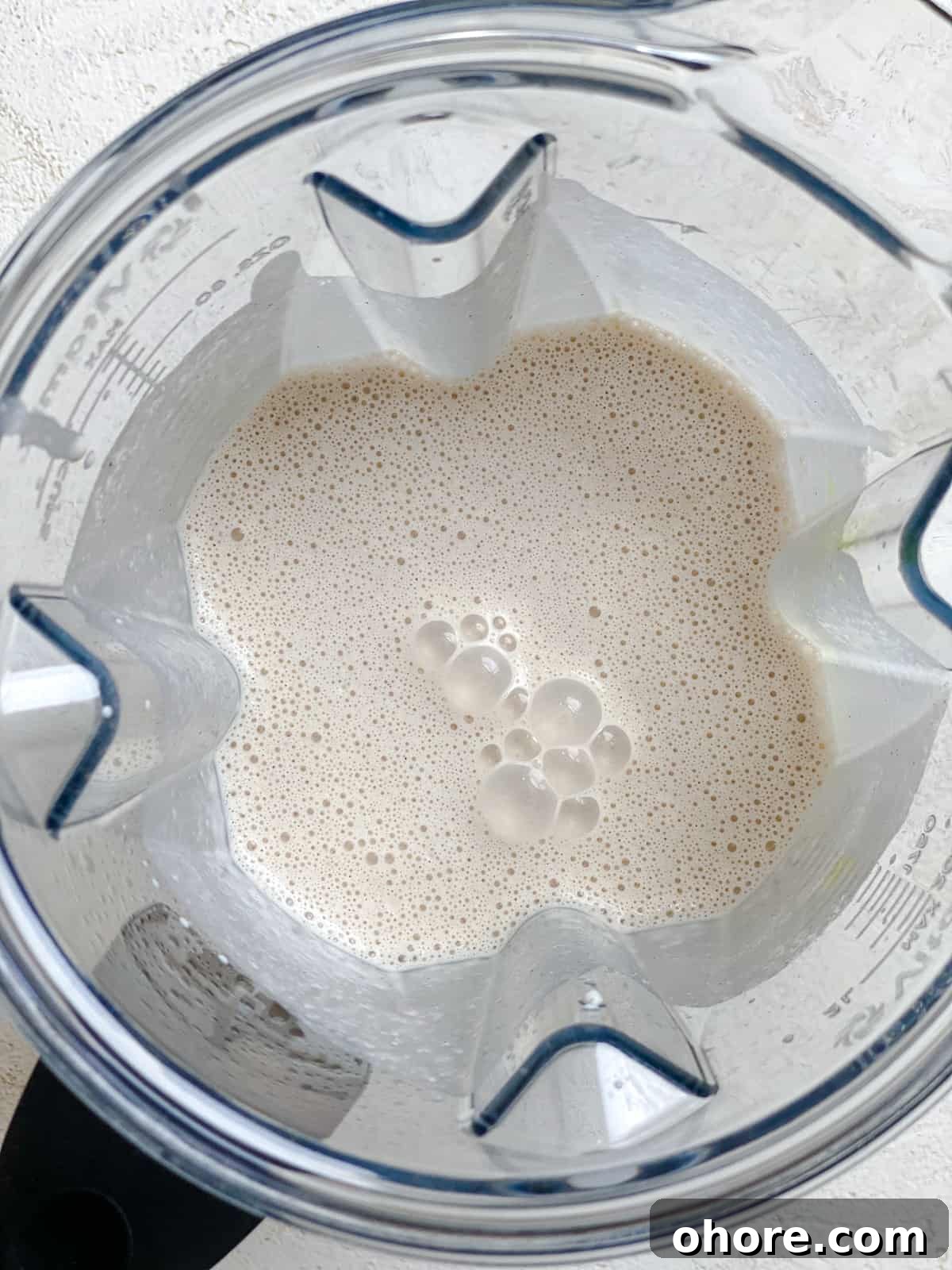 process shot of adding plant based milk to blender