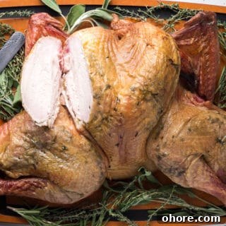 Spatchcocked Whole Turkey Smoked on a Traeger Grill 12 smoked turkey on a cutting board with a breast cut out