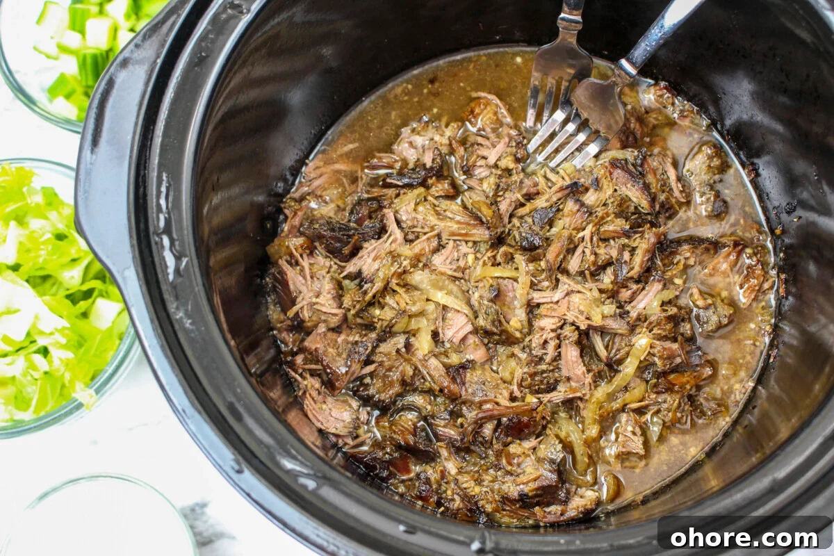 Slow Cooker Beef Gyros Recipe: Tender, Flavorful Greek Sandwiches 8 shredded beef gyro meat in slow cooker.
