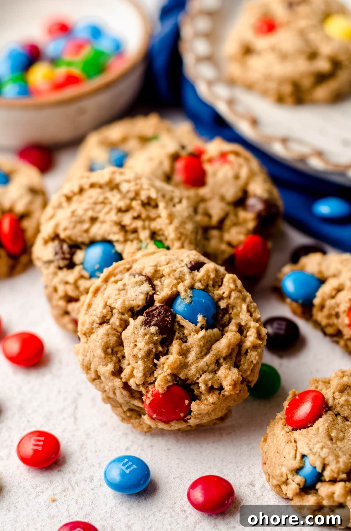 Ultimate Monster Cookie Recipe for Chewy, Loaded Cookies 3 monster cookies with m&m's scattered around