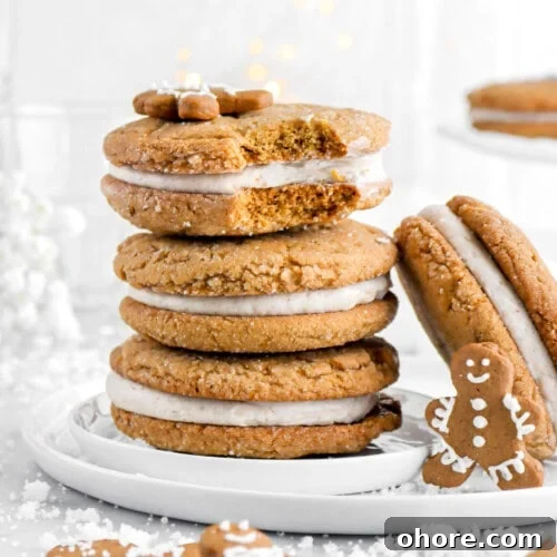 Gingerbread Sandwich Cookies Recipe for Holiday Parties 11 three stacked sandwich cookies with top cookie missing a bite.