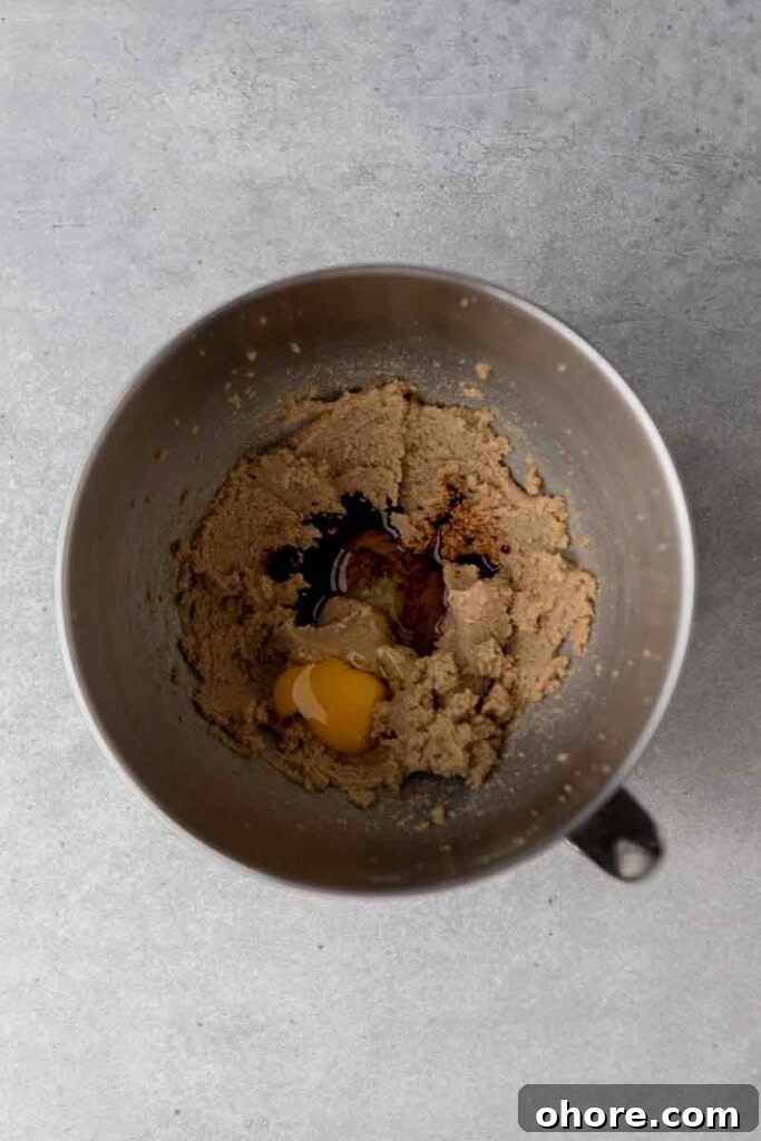 Creamed butter with eggs in mixing bowl