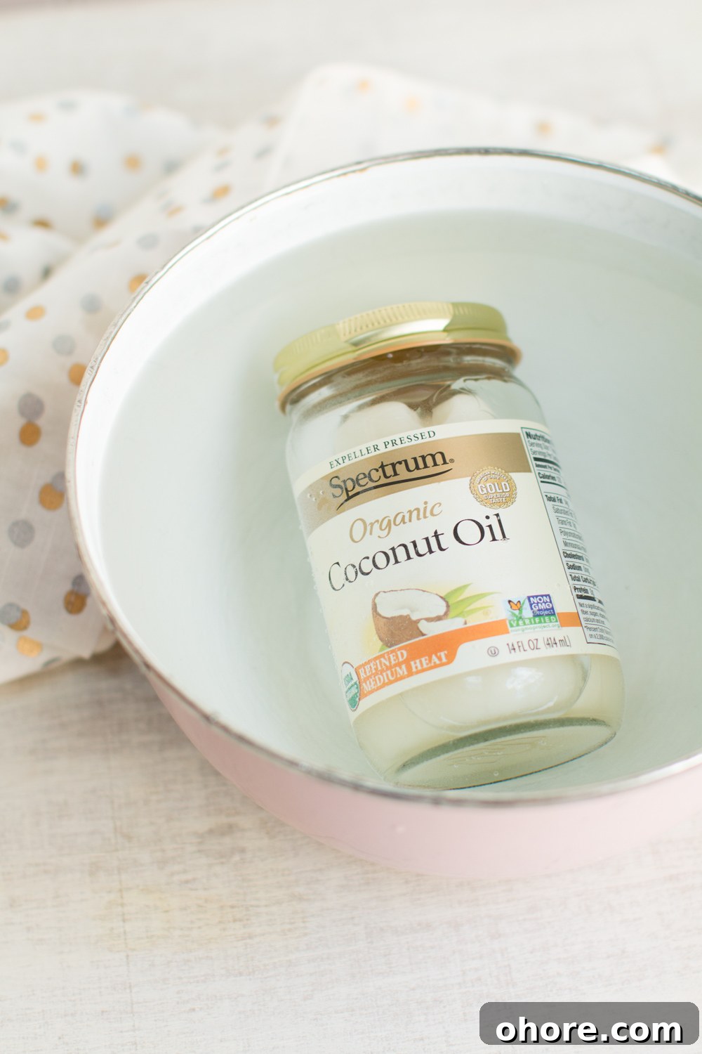 liquefy coconut oil by submerging the jar in a bowl of hot water