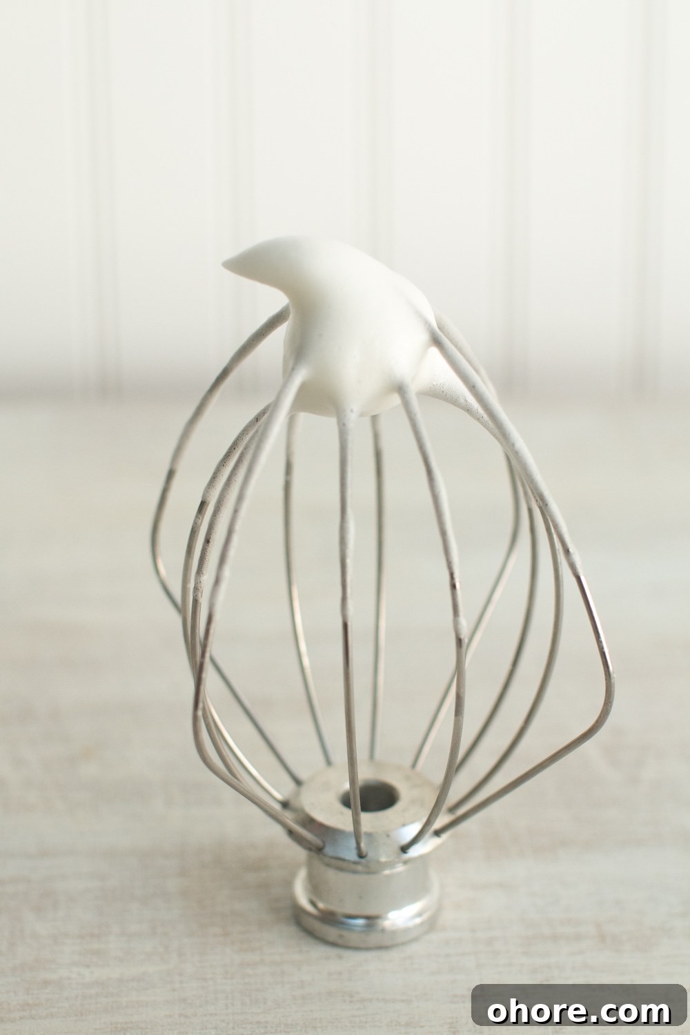 egg whites and sugar whisked together forms an airy mix that stands up at the tip of the whisk in a soft peak when placed upside down