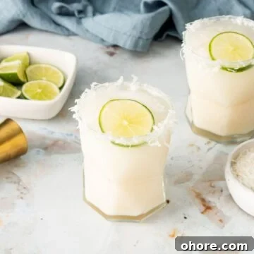 Coconut cream cocktail with shredded coconut rim.