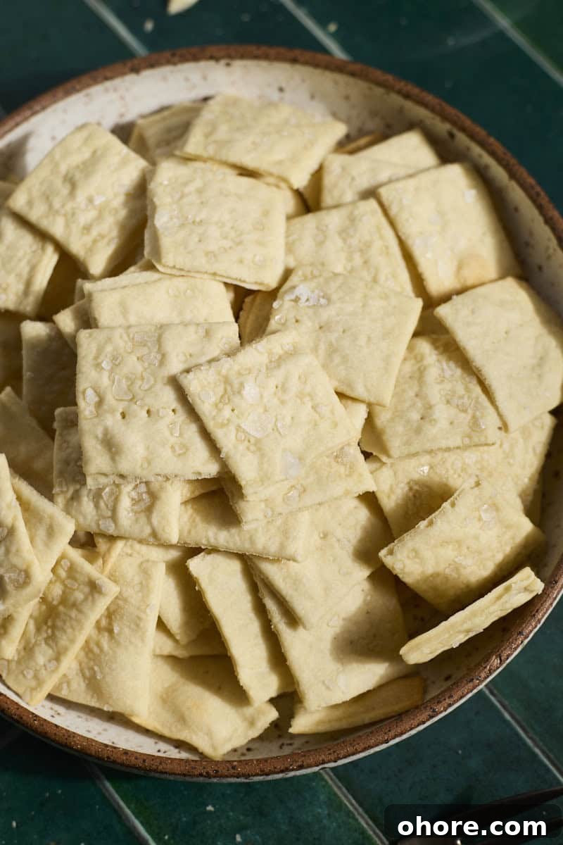 Crispy Sourdough Discard Crackers Recipe for Zero-Waste Snacking 11 Sourdough Discard Crackers in a bowl.