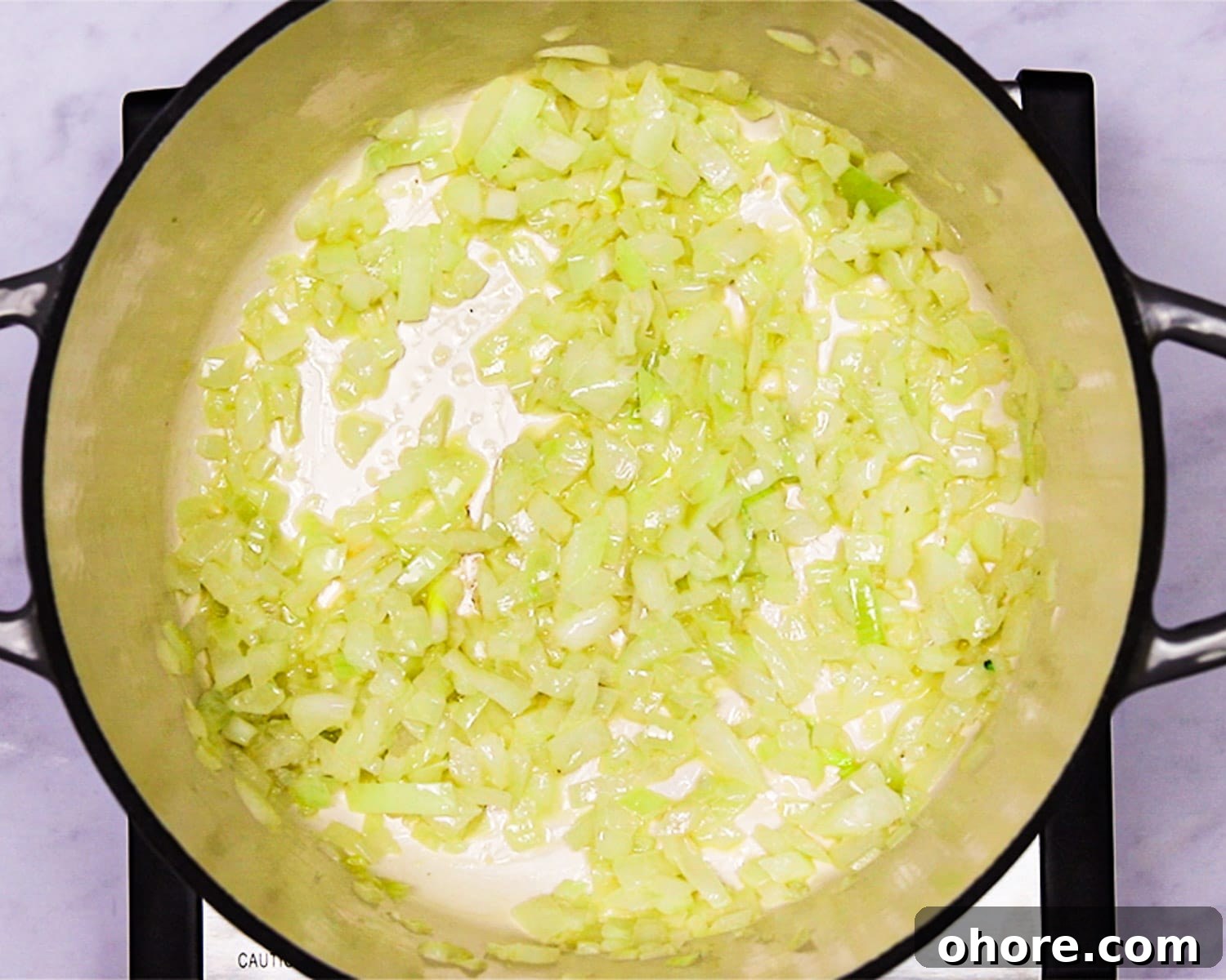 Creamy Broccoli Cheddar Soup Recipe for Cozy Comfort Meal 4 Sauteed onion and garlic in a Dutch oven.