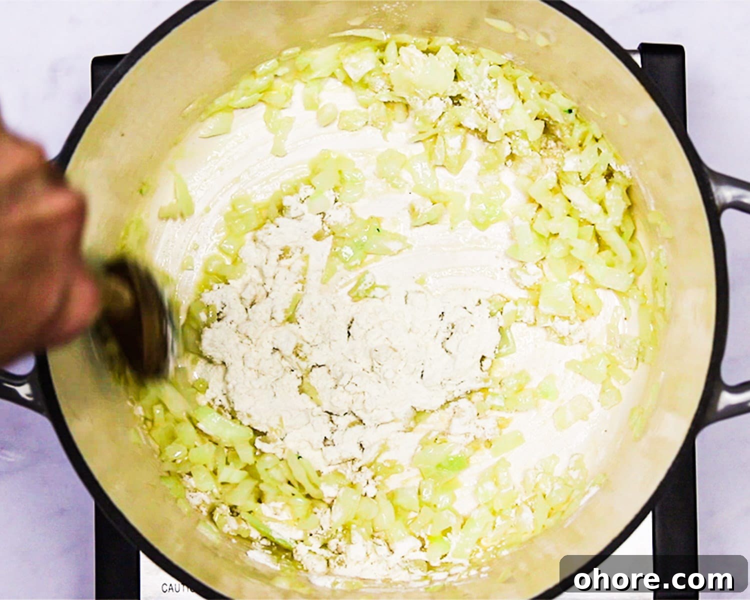 Creamy Broccoli Cheddar Soup Recipe for Cozy Comfort Meal 5 Adding flour to the roux in a Dutch oven.